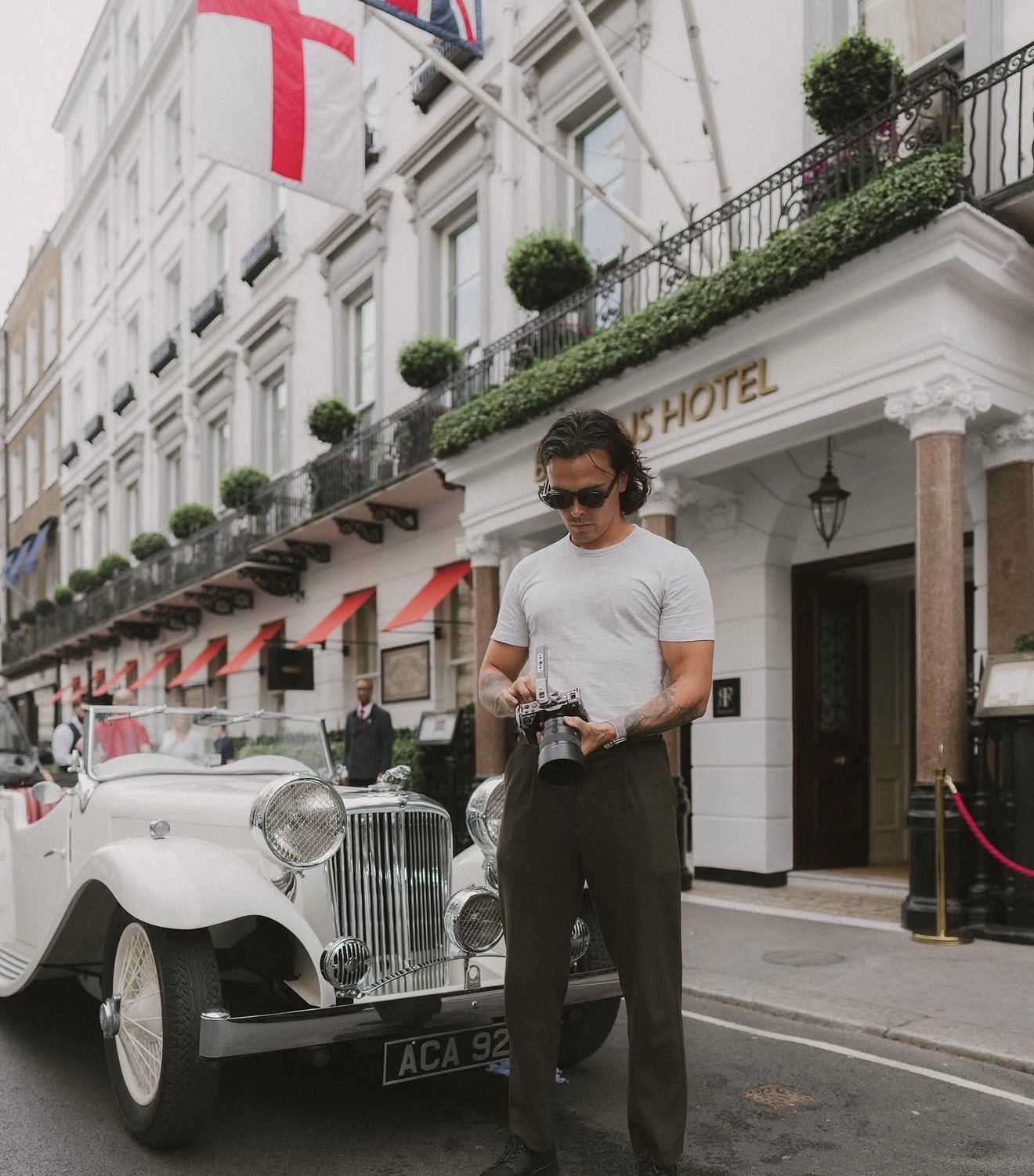 Aaron Greenfield, founder of Project You Media, photographing outside Brown's Hotel in Mayfair, London